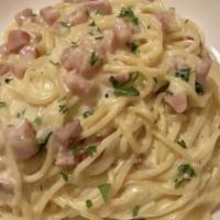 Spaghetti Alla Carbonara · Spaghetti with diced pancetta and egg in a cream and Parmesan cheese sauce.