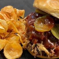 Pulled Pork Sandwich · Smoked pulled pork, BBQ sauce, and pickles on a brioche bun. Served with our house chips.