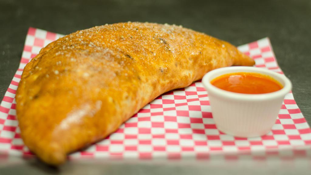 Greek  Calzone · Cheese with spinach, feta cheese, artichoke hearts, sun-dried tomatoes and banana
peppers.