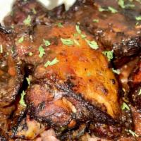 Jerk Chicken · Served with your choice of either Jollof rice or Jamaican rice and peas and cabbage. Optiona...