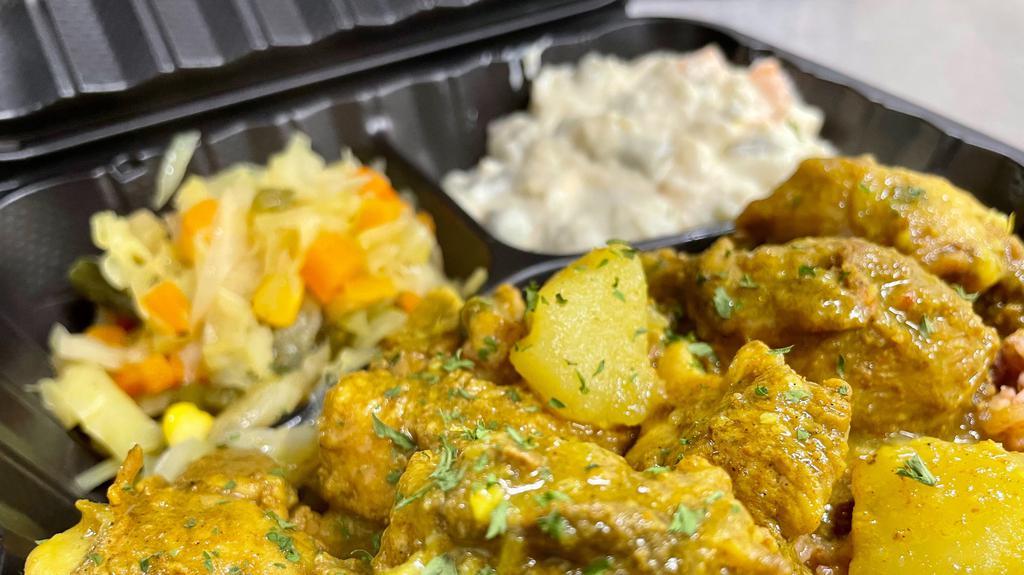 Curry Chicken · Served with your choice of either Jollof rice or Jamaican rice and peas and cabbage.