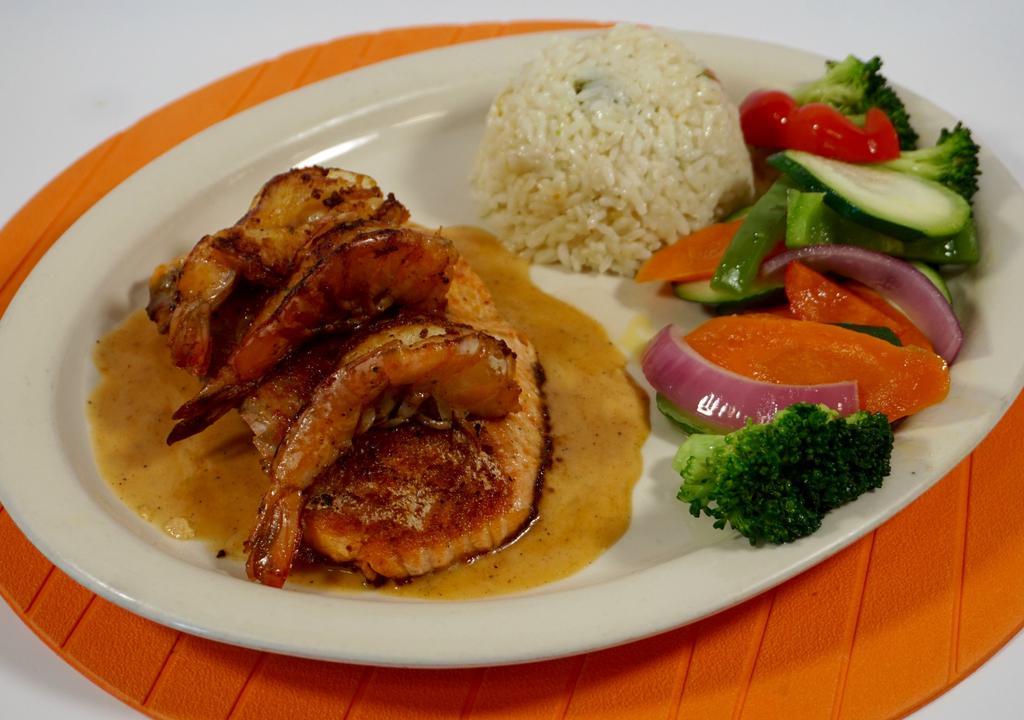 Salmon · Grilled salmon topped with shrimp and lobster cream sauce served with rice and vegetables.