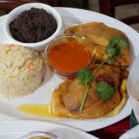 Chiles Rellenos · Bell pepper stuffed with pork and potatoes, served with rice, tomato sauce, refried beans an...