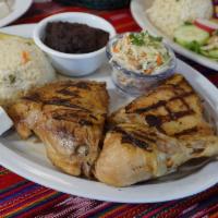Pollo Asado · Grilled chicken leg quarters, served with rice, refried beans, avocado, mayo salad and mixed...