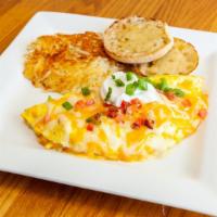 Royal Omelet · Ham, sausage, bacon, veggies, mushrooms and Cheddar Jack cheese. Topped with Cheddar Jack ch...