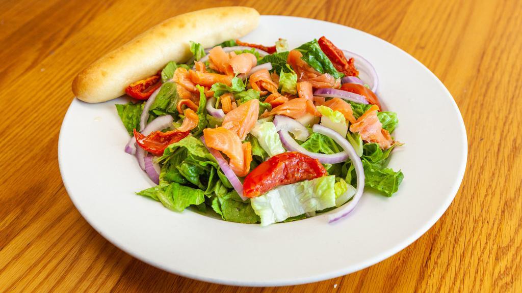 Smoked Salmon Salad · Romaine and spinach, tossed in lemon vinaigrette. Topped with roasted red tomatoes, red onions and cold smoked salmon. Served with a garlic breadstick.