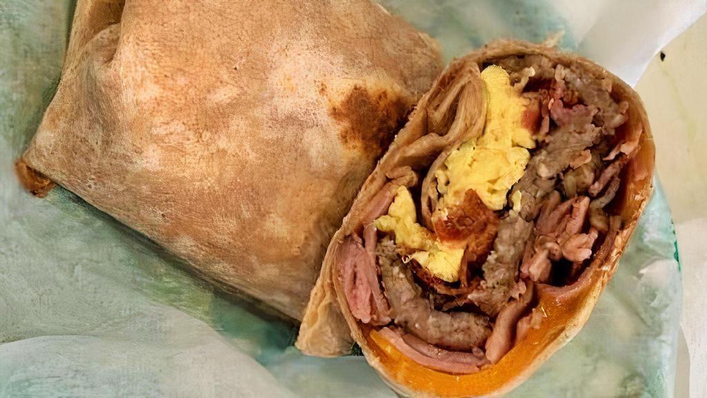 Meated Up Egg Wrap · Three eggs, bacon, ham, sausage and cheddar in a wheat wrap.