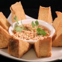 Crispy Tofu · Crispy fried tofu served with homemade sweet and sour sauce topped with crushed peanuts.