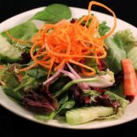 House Salad · Spring mix, tomatoes, cucumber, red onion and carrot served with your choice of Ginger or Pe...