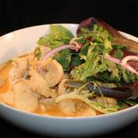 Kaow Soi · Wheat noodles in a mild coconut curry sauce, topped with spring mix, cilantro and red onion.
