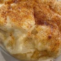 Potato Au Gratin · ROASTED GARLIC SCALLOPED POTATOES BAKED IN A CREAMY BÉCHAMEL SAUCE TOPPED WITH MELTED GRUYERE