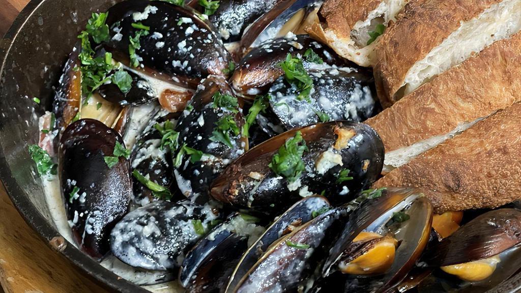 Drunken Mussels · Fresh mussels steamed in creamy broth of olive oil, white wine, garlic & ginger. served with house baked bread.