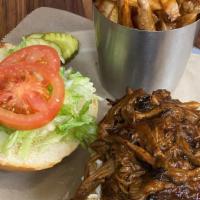 Bbq Brisket · Slow cooked Pulled brisket served on a brioche roll with Lettuce tomato & Slaw.