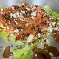 Wedge Salad · Thick cut iceberg lettuce, topped with diced bacon, tomatoes, bleu cheese crumbles. & house ...