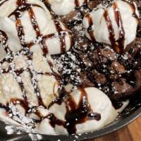 Fudge Brownie Skillet · Warm Fudge brownie served warm with two scoop of ice cream and Chocolate sauce topped with w...