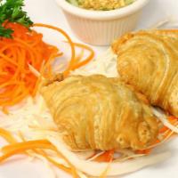 Curry Pup · Two crispy pastry stuffed with curry chicken and potatoes served with sweet vinegar sauce.