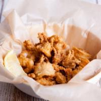 Crispy Calamari · Deliciously seasoned tender pieces of squid soaked in buttermilk, then coated in seasoned fl...