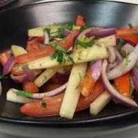 Kachumber Salad · Red onions, tomatoes, cucumber, mixed with lemon-lime vinaigrette