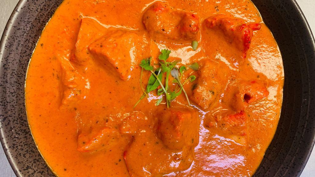 Butter Chicken · Tandoori chicken tikka in a creamy tomato and butter flavored sauce with a hint of ginger, green cardamom and fenugreek