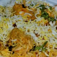 Dum Biryani · Fragrant basmati rice cooked in a sealed pot with herbs and spices.