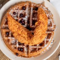 Connies Chocolate Chip Waffle With Chicken Breast Tenders. · Two chicken breast tenders and a chocolate chip Belgian waffle with maple syrup.
