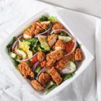 Chicken Tender Salad · Fried chicken tenders, red onions, tomato, cucumbers, cheese, and your choice of dressing.