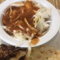 Pupusas · Corn filled tortilla served with vinaigrette coleslaw and tomato salsa.