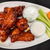 Smoked Honey Hot Wings · Ancho-rubbed jumbo wings smoked and fried, glazed with Honey Hot Wing Sauce and served with ...