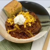 Smoked Brisket Chili · Smoked brisket, chipotle and ancho chiles. One cup of chili served with cheddar, sour cream,...