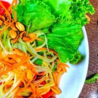 Green Papaya Salad · Sliced green Papaya, tomatoes, green beans, peanuts, tossed in spicy lime dressing. **Allerg...