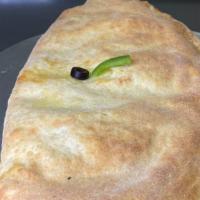 Veggie Calzone · Green peppers, mushrooms, onion, sliced tomato, black olives, mozzarella and sauce.