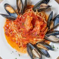 Salmon Messinese · Fresh fillet of salmon sautéed with capers, olives, mussels in a light marinara sauce.