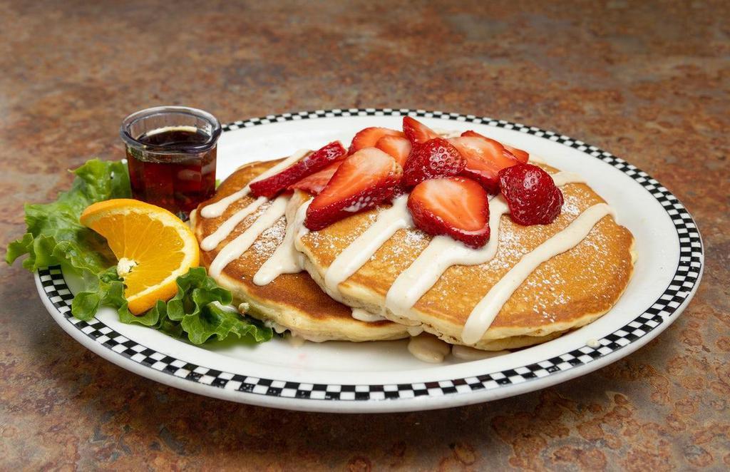 Sweet Cream Pancakes With Fresh Strawberries & Lemon Cream · Our one-of-a-kind sweet cream pancakes topped with a sweet-tart lemon cream sauce made in-house from fresh-squeeze lemons.  Topped with juicy, fresh strawberries for a decadent delight.