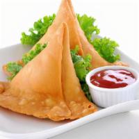 Samosa · Two crispy turnover filled mildly spiced potatoes and green peas