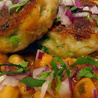 Aloo Tikki Chaat · Two mildly spiced crispy potato patties topped with chickpeas, spiced onion and chutney