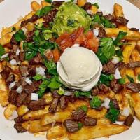 Carne Asada Fries  · Order of fries topped with chile con queso, shredded cheese, carne asada, onion, cilantro, t...