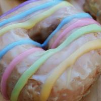 Pride Donut  · Sprinkle confetti cake donut dipped in our original vanilla glaze and topped with pride stri...