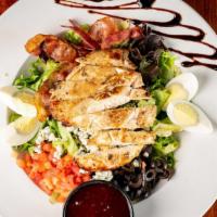 Chicken Cobb Salad · Grilled chicken on a bed of field greens, topped with black olive, tomato, bacon, Bleu chees...