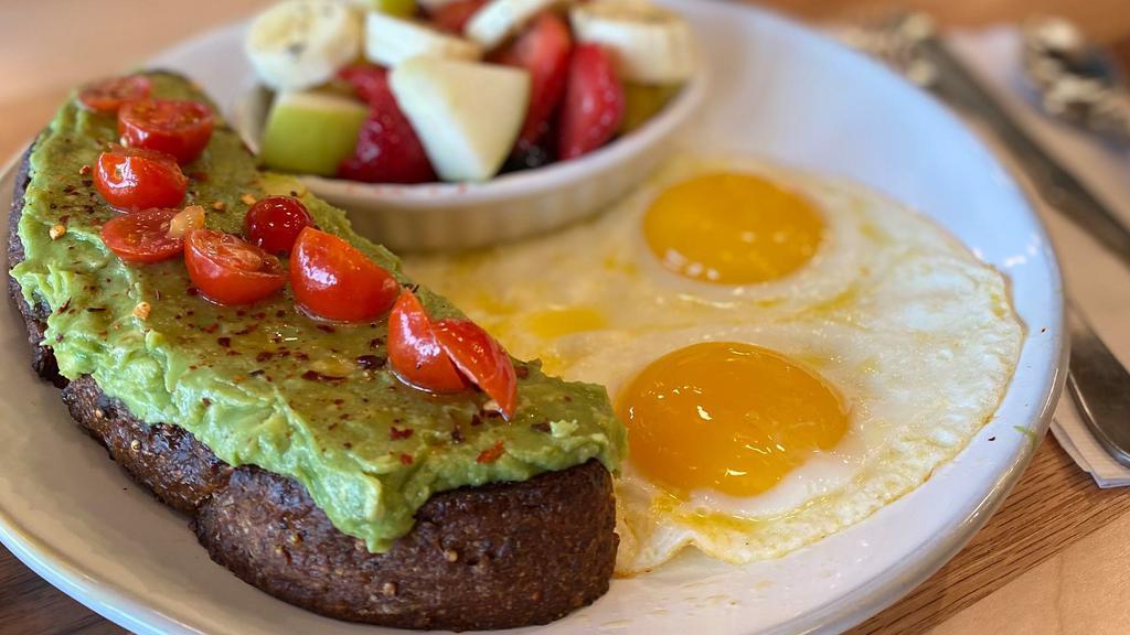 Avocado Toast · Fresh avocado mash, grape tomatoes, crushed red peppers on great grain Farm to Market bread and a drizzle of olive oil, with two pasture-raised eggs and fresh fruit.