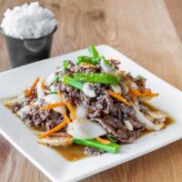 Bulgogi · Marinated ribeye stir fried with vegetables served with steamed rice.