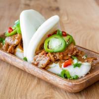 Spicy Pork Buns · Steamed buns filled with spicy pork, pickled jalepenos, mayo, and sesame seeds.