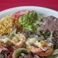 Rodeo Especial · Beef & Shrimp Fajita covered w/ monterrey jack cheese , spanish rice, refried beans & guacam...