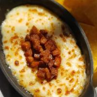 Queso Fundido · Gluten free. Mexican cheese fondue, served with corn tortilla chips add chorizo for addition...