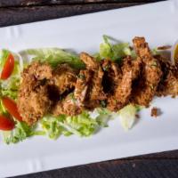 Coconut Shrimp · 6 large shrimp breaded with coconut and served with a mango salsa
