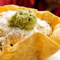 Burrito Bowl · fried tortilla bowl layered with rice , beans guacamole , pico , crema,topped with red & gre...