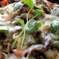 Alambre  · sautéed steak chicken shrimp peppers onions and melted mixed cheese on top served with 3 flo...