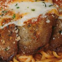 Eggplant Parmigiana · Fresh breaded eggplant, baked with cheese, covered with marinara and served over linguine.