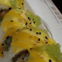 Golden Dragon Roll · Salmon, avocado, cucumber with slice mango and green tobiko on top, chef special sauce.
