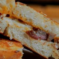 Cattleman'S Grilled Cheese · Brisket, muenster, gouda, yellow cheddar on Rustic with BBQ sauce on the side,