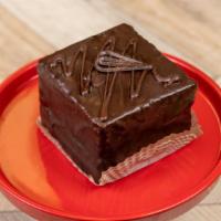 Chocolate Tower · Layers of chocolate cake filled with chocolate buttercream and chocolate mousse finished wit...